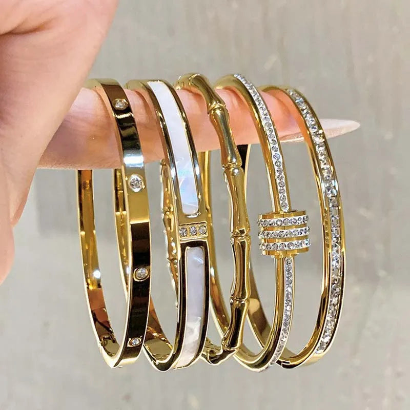 Women's Gold Bracelets Charming and sophisticated, these gold bracelets with sparkling stone accents and an elegant finish are perfect to complement any look.