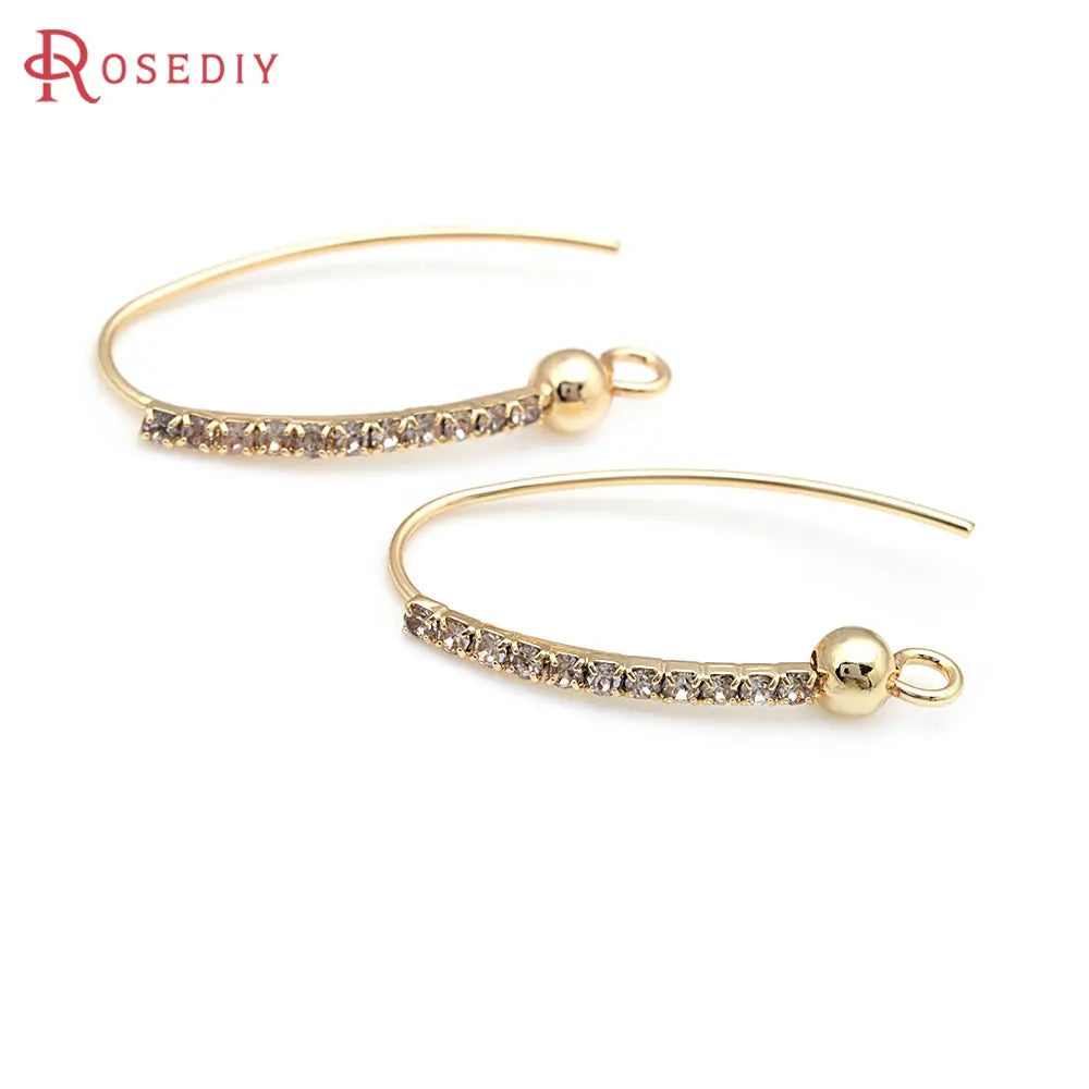 Gold Earrings with Crystals Delicate and sophisticated, these gold earrings feature a curved design with sparkling crystals, perfect for adding a touch of elegance to your look.