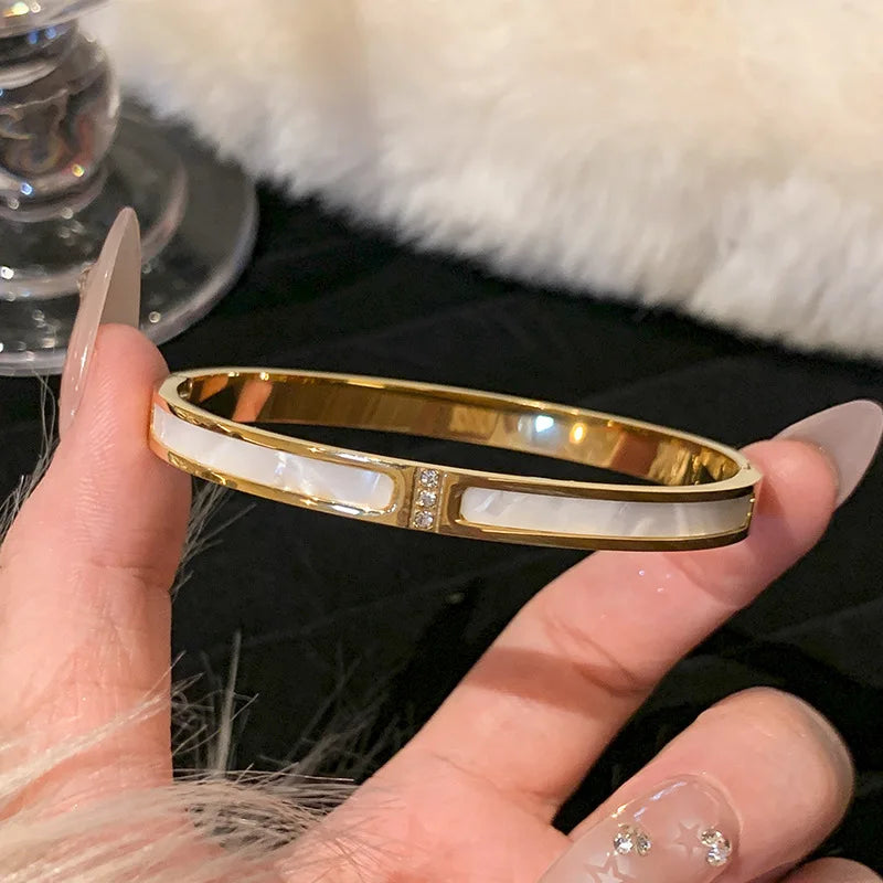 Women's Gold Bracelets Charming and sophisticated, these gold bracelets with sparkling stone accents and an elegant finish are perfect to complement any look.