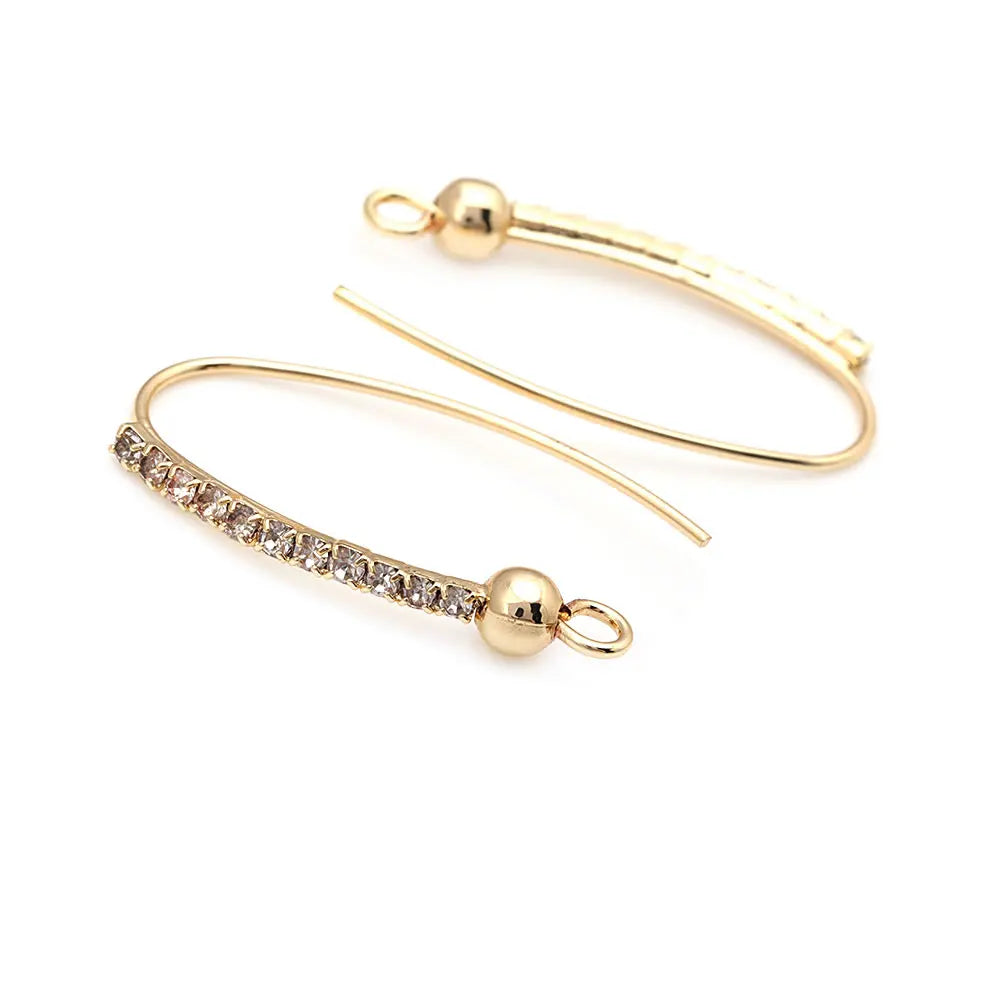 Gold Earrings with Crystals Delicate and sophisticated, these gold earrings feature a curved design with sparkling crystals, perfect for adding a touch of elegance to your look.