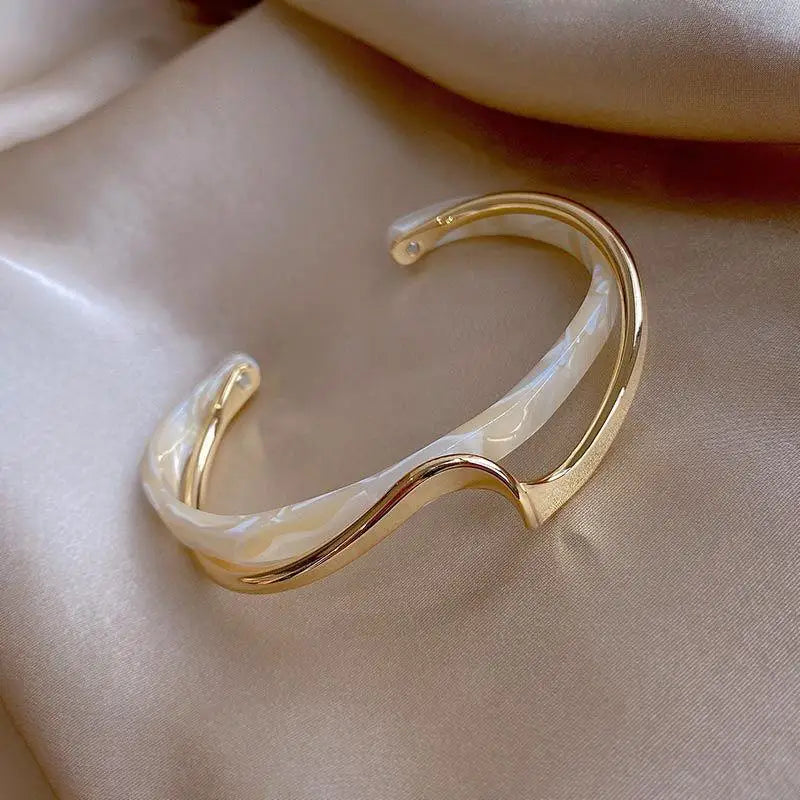 Women's Gold Bracelets Charming and sophisticated, these gold bracelets with sparkling stone accents and an elegant finish are perfect to complement any look.