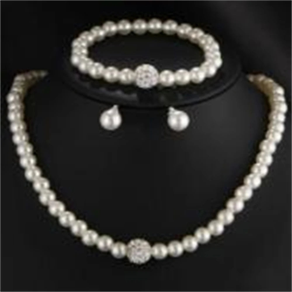 Pearl Jewelry Set Classic and elegant, this set includes a pearl necklace, bracelet, and earrings, accented with crystal details. A timeless choice for any special occasion.