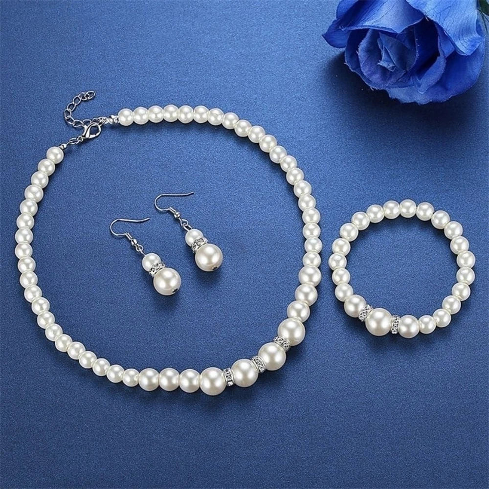 Pearl Jewelry Set Classic and elegant, this set includes a pearl necklace, bracelet, and earrings, accented with crystal details. A timeless choice for any special occasion.
