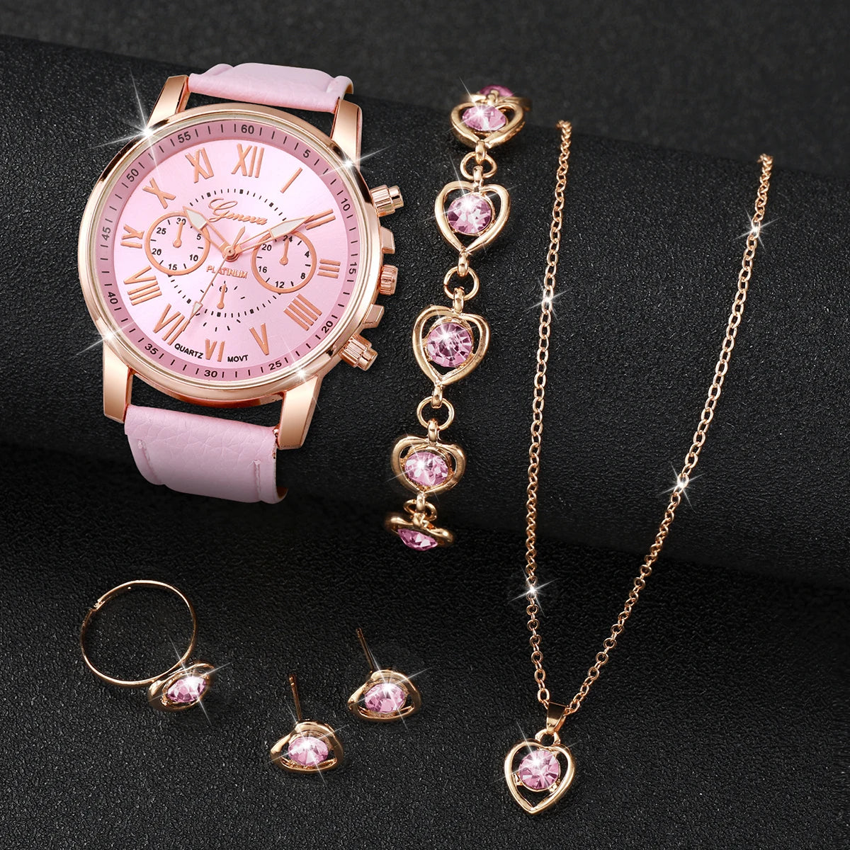 Women's Watch and Jewelry Set Elegant and delicate, this set includes a pink watch, bracelet, necklace, earrings, and ring with heart details and sparkling pink stones. Perfect for gifting or complementing your style.
