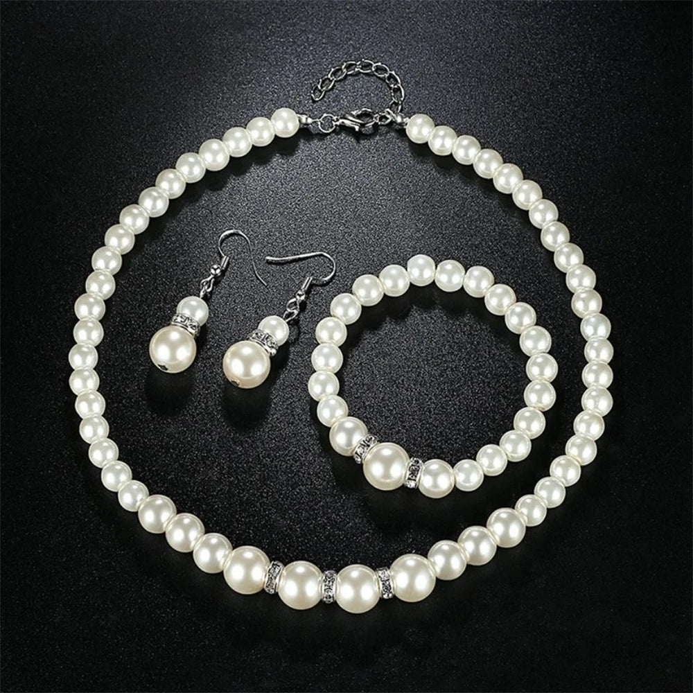Pearl Jewelry Set Classic and elegant, this set includes a pearl necklace, bracelet, and earrings, accented with crystal details. A timeless choice for any special occasion.