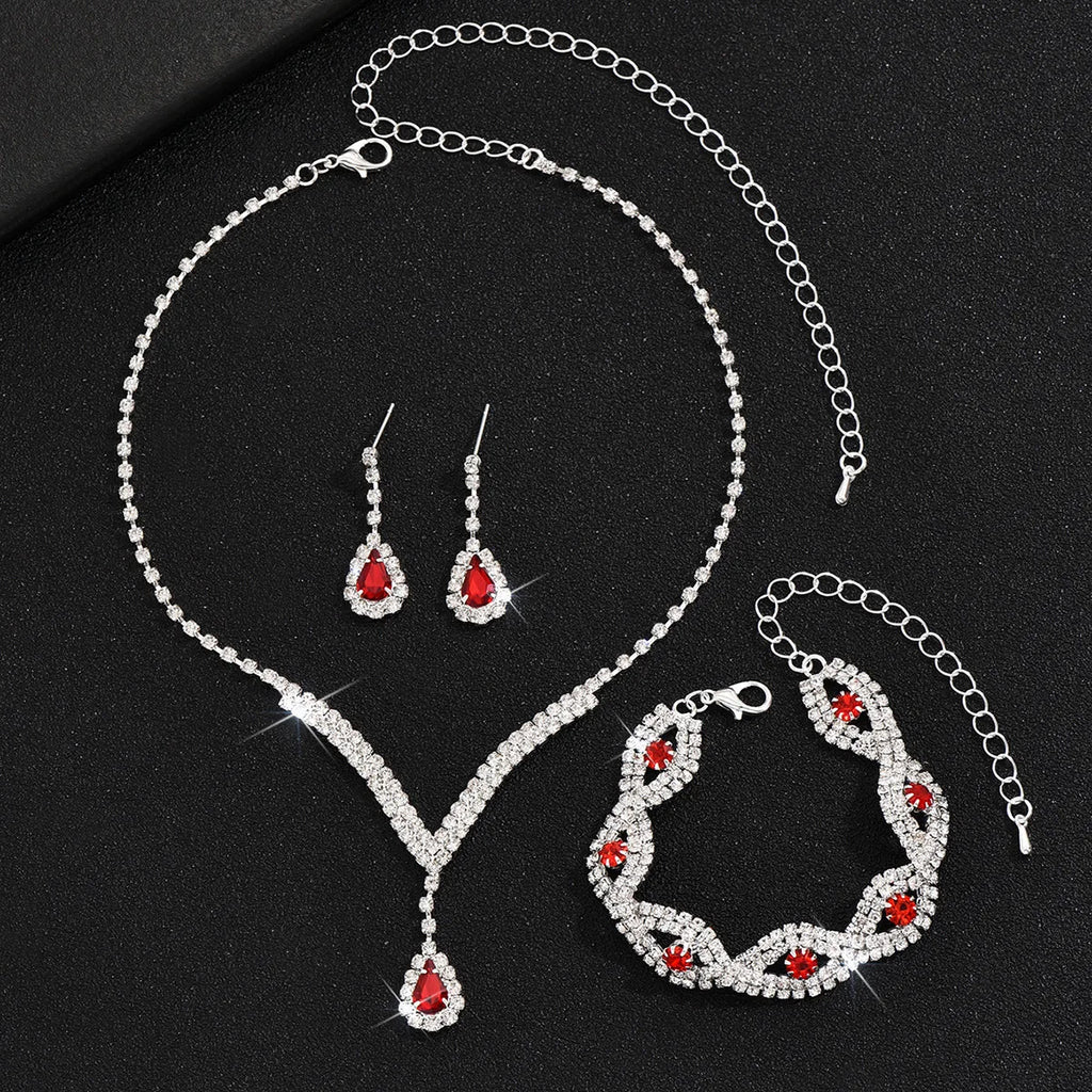Luxury Silver Jewelry Set with Black Stones A sophisticated set comprising a necklace, earrings, and bracelet, all adorned with teardrop-shaped black stones and sparkling crystal accents. Perfect for special occasions.