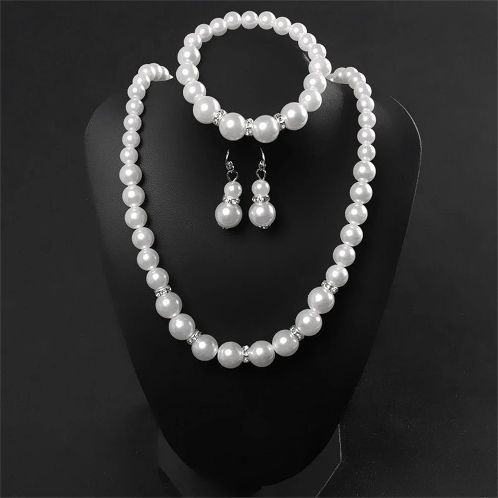 Pearl Jewelry Set Classic and elegant, this set includes a pearl necklace, bracelet, and earrings, accented with crystal details. A timeless choice for any special occasion.