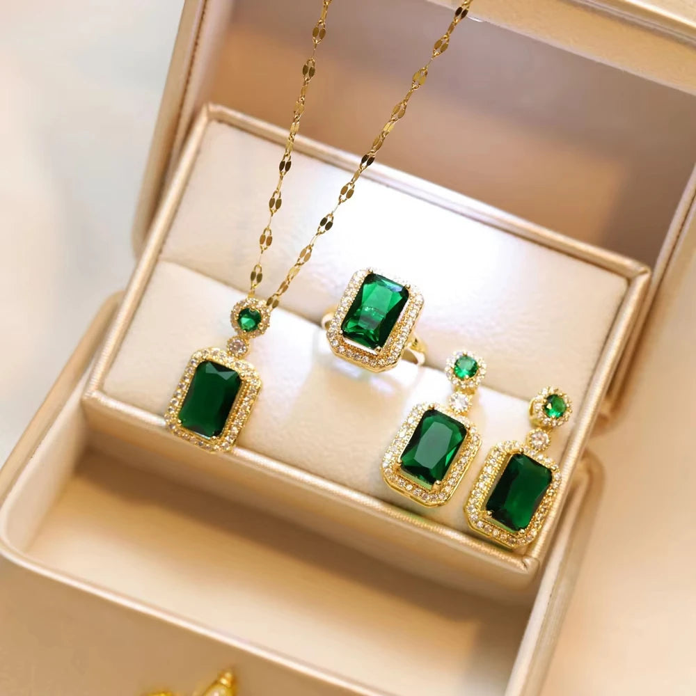 Classic set consisting of three women's jewelry pieces: jadeite ring, green zirconia ring, earrings, necklace