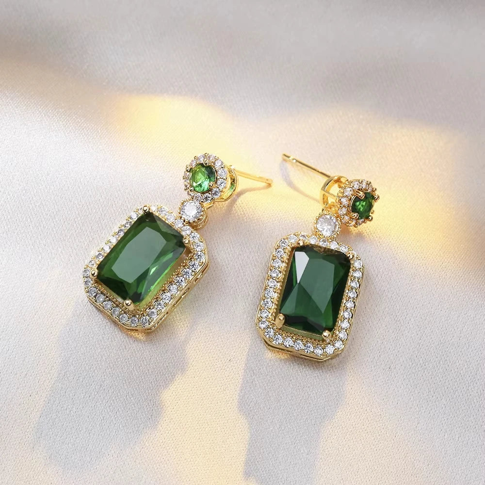 Classic set consisting of three women's jewelry pieces: jadeite ring, green zirconia ring, earrings, necklace