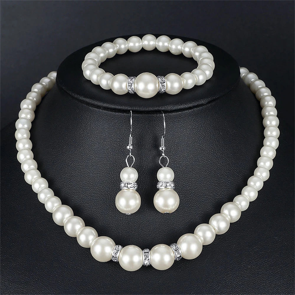 Pearl Jewelry Set Classic and elegant, this set includes a pearl necklace, bracelet, and earrings, accented with crystal details. A timeless choice for any special occasion.