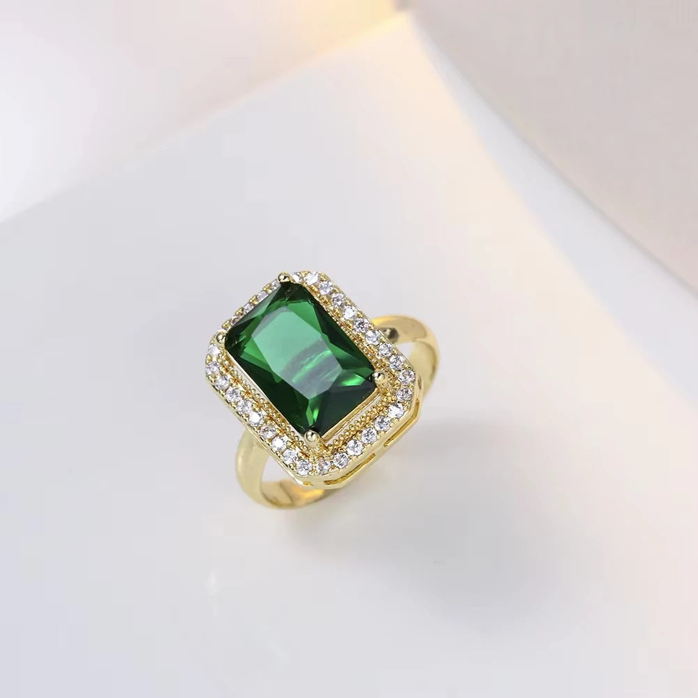 Classic set consisting of three women's jewelry pieces: jadeite ring, green zirconia ring, earrings, necklace